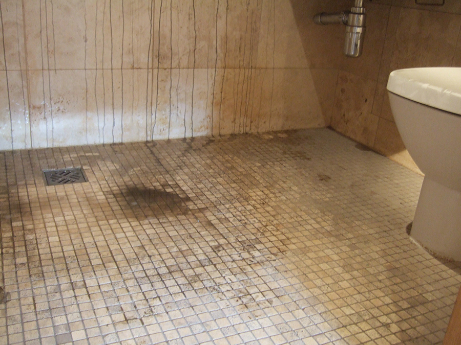 Fire damaged travertine tiles in a bathroom