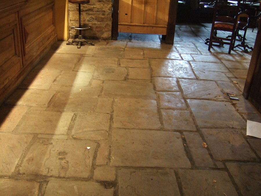 Flood damaged flagstone floor in a restaurant in oxford shire