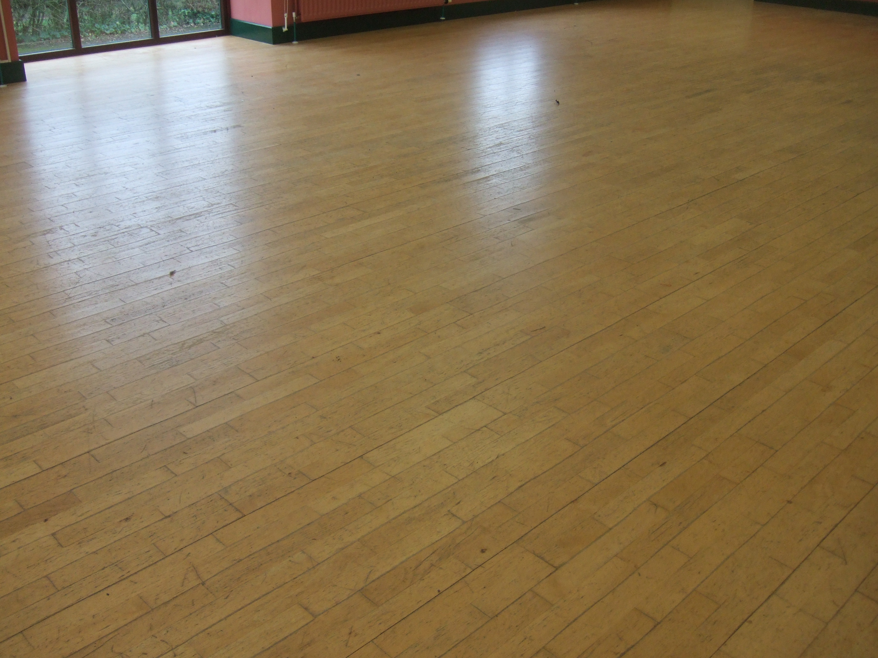 Community hall with damaged beech laminate flooring 
