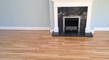 Beech floor in a living room with fireplace