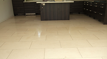 Limestone floor tiles in a kitchen polished.