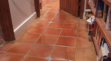 Terracotta floor tiles with stain proof seal in a hallway