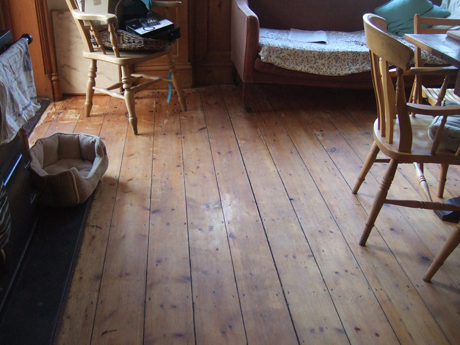 Worn old pine floor before restoration